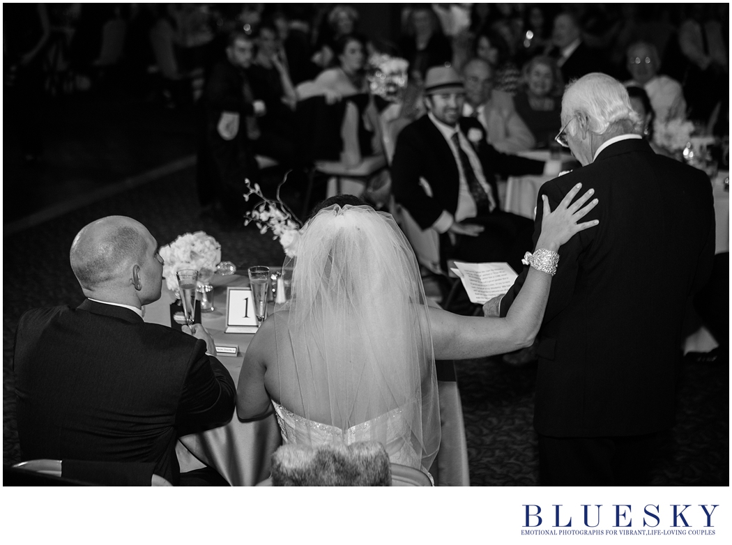 bride touching dads shoulder during toasts