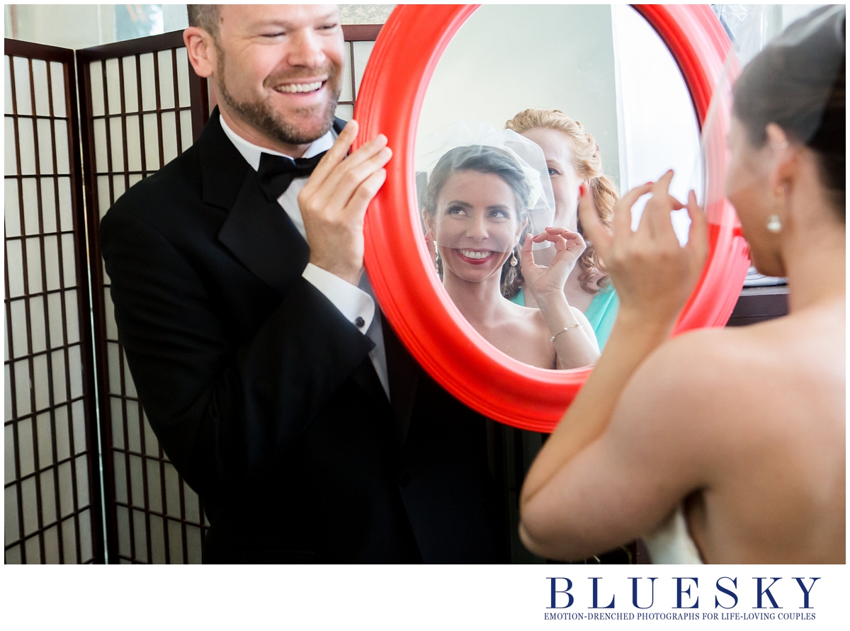 bride getting ready relection in red mirror
