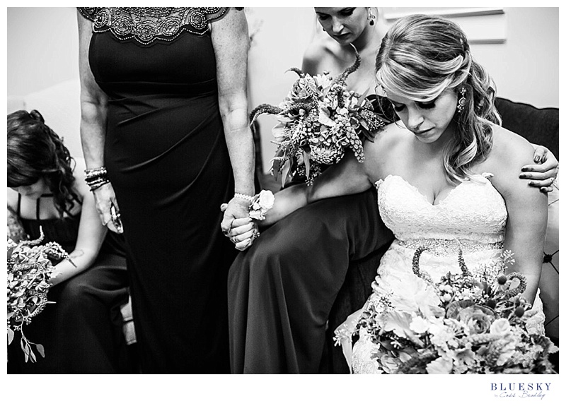 bride and bridesmaid praying before wedding
