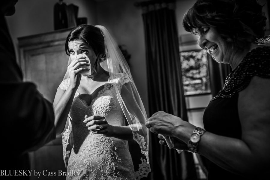 bride crying after first look with dad