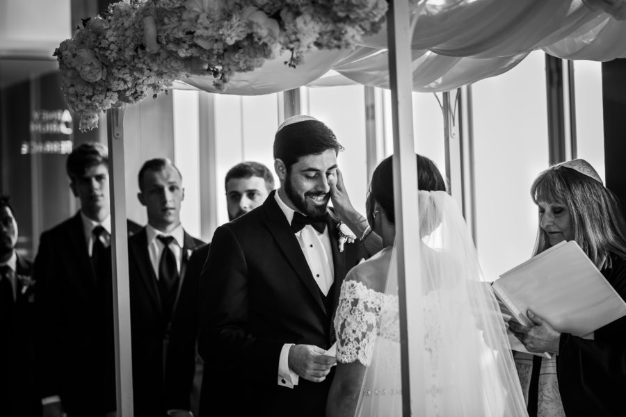 bride wipes grooms tears during ceremony 