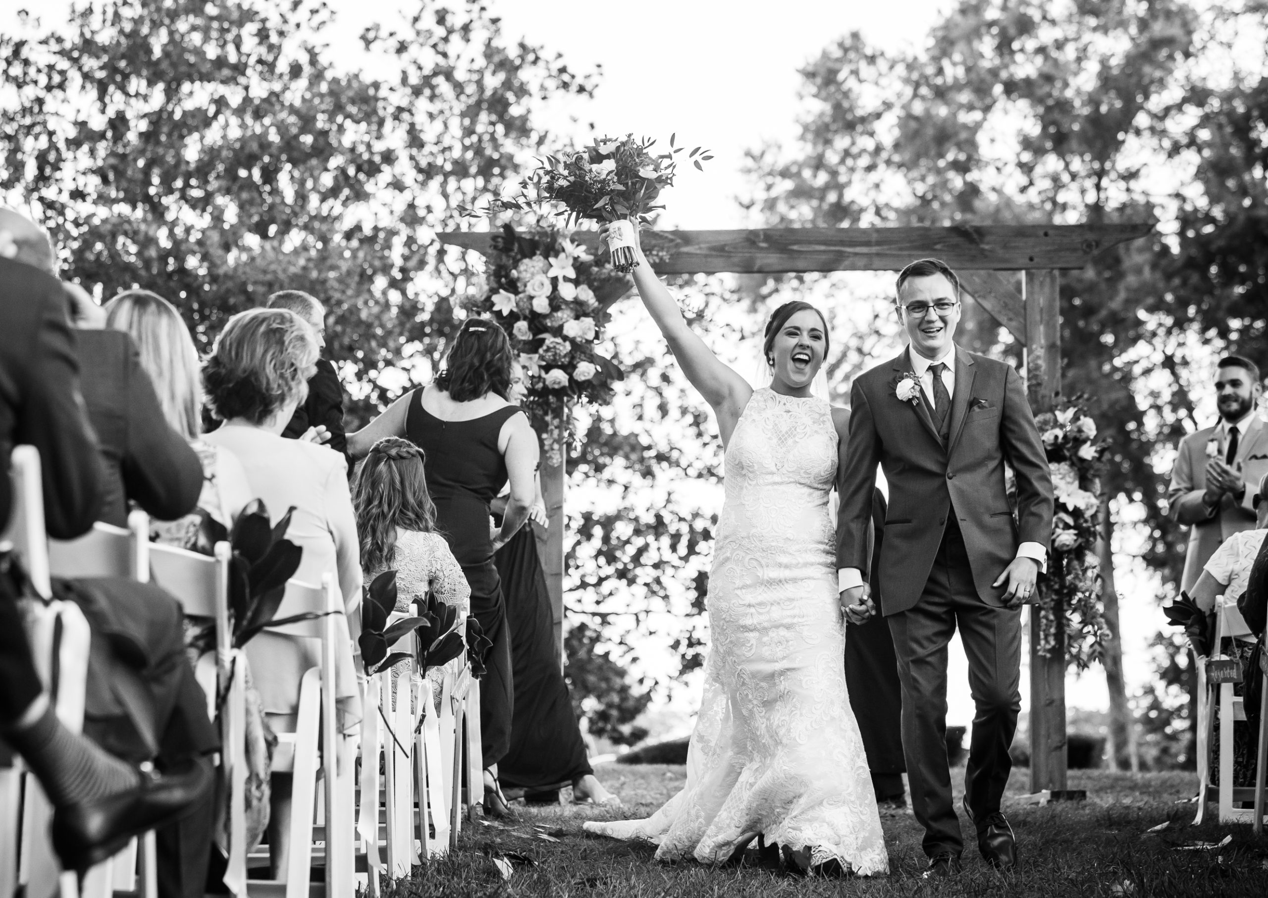 Bride with arm in the air celebrating after announced husband and wife