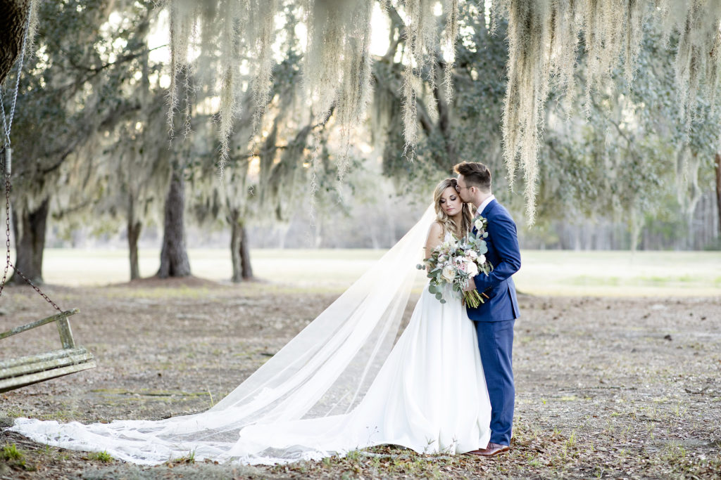 Bride and groom surrounded by Spanish Moss