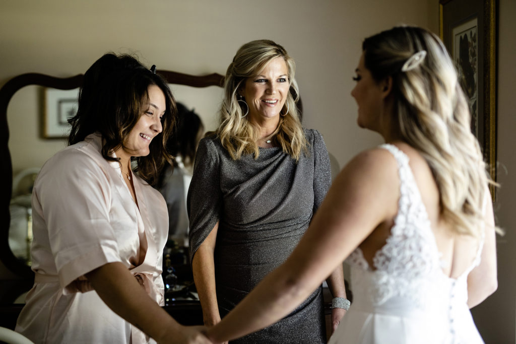 Brides mom and best friend get emotional after seeing the bride for the first time