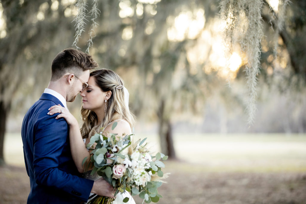 Posing ideas for bride and groom. Backyard Sweet Savannah wedding in March with a ceremony in front of Spanish Moss trees