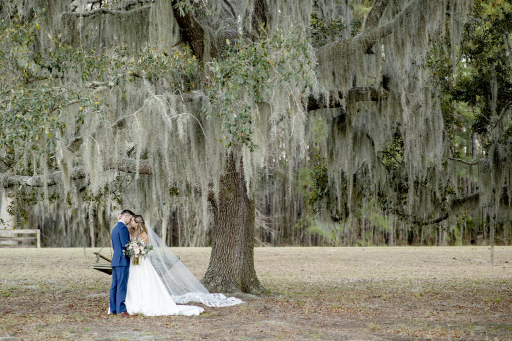 Posing ideas for bride and groom. Backyard Sweet Savannah wedding in March with a ceremony in front of Spanish Moss trees