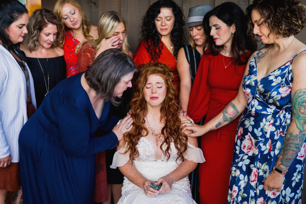 Love and support as the bridesmaids pray over the bride.