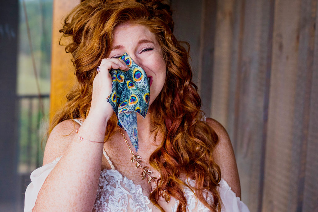 bride is over joyed as she reads a heartfelt letter to her own son. Candid photographer