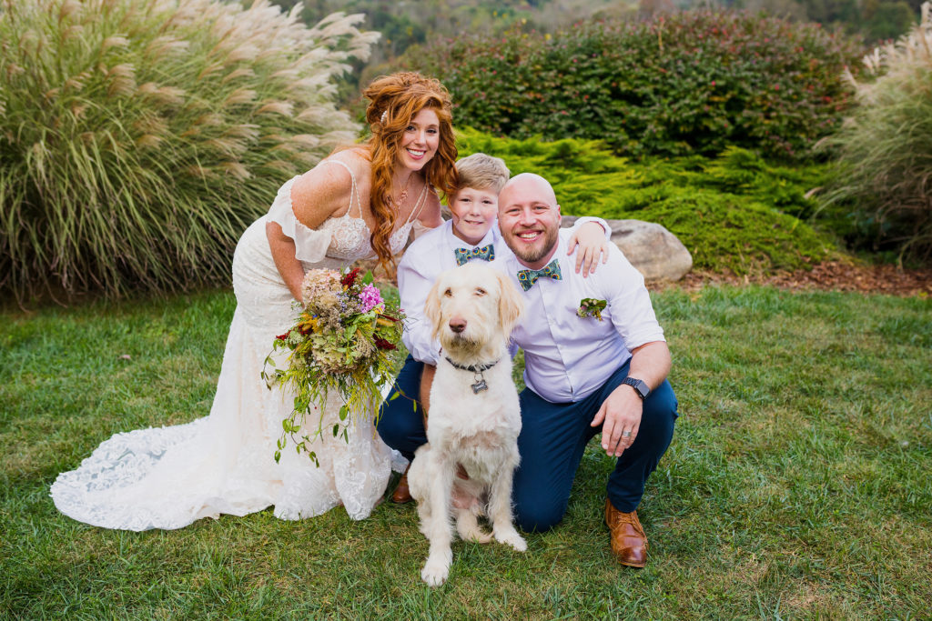 family portrait with their dog on their wedding day. Including your dog on your wedding day. Joyful, fun wedding couple. Intimate micro wedding in the blue ridge parkway in asheville nc