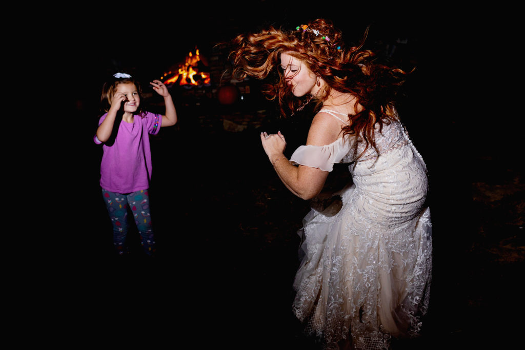 Bride dancing with fire pit in the background. Intimate micro wedding in the blue ridge parkway in asheville nc