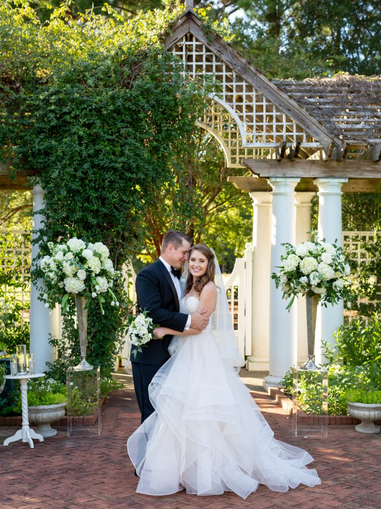  Bride and groom on their wedding day at Daniel Stowe Botanical Gardens in the White Garden. Greenhouse and garden weddings