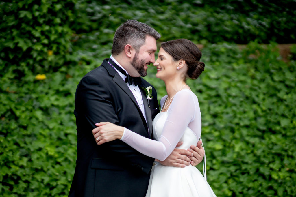 Wedding couple by greenery - Wedding at The Grove Park Inn in Asheville, NC